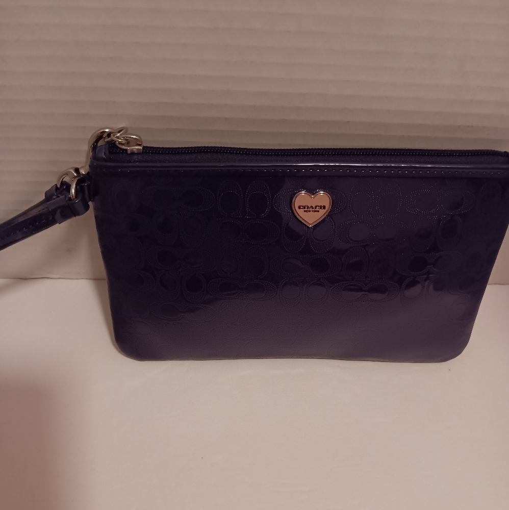 Coach dark purple wristlet,the strap has minor flaws, slight inside fading